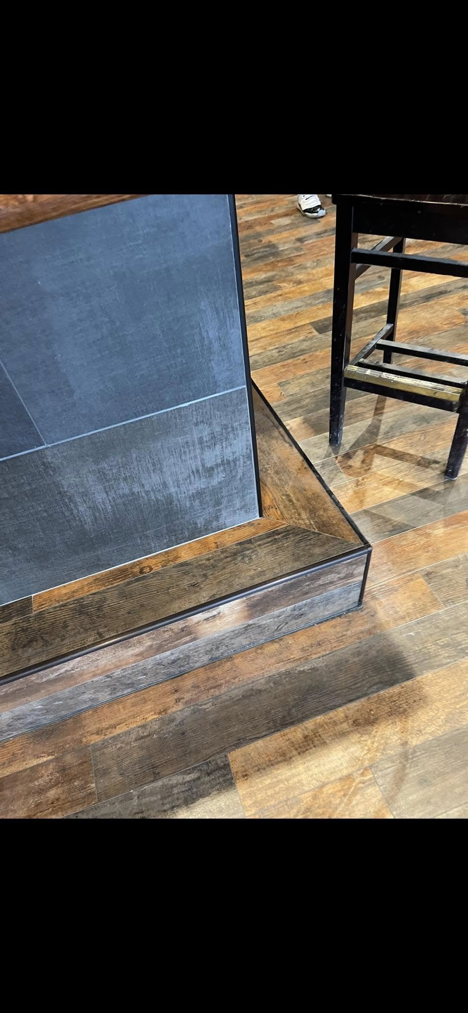 JNL Flooring restaurant bar base with tile and adjoining wood-look plank flooring